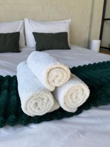 a pile of towels on top of a bed at Studio in Woodstock in Cape Town