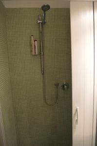 a shower with a shower head in a bathroom at La Sorgente B&B in Cetara