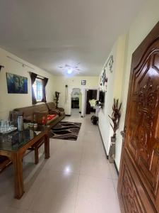 a living room with a couch and a table at Sparrow valley in Coonoor