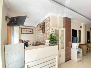a kitchen with a christmas tree on the counter at Lily Guest House Syariah RedPartner in Bunul