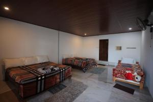 a room with two beds in a room at Coorg Backwaters in Suntikoppa