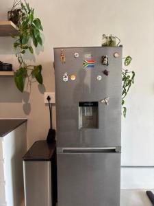 a refrigerator with magnets on it in a kitchen at Studio in Woodstock in Cape Town