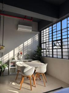 a dining room with a white table and chairs at Studio in Woodstock in Cape Town