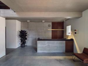 a lobby with a reception desk and a potted plant at Moderninfluence - Aparthotel in Porto