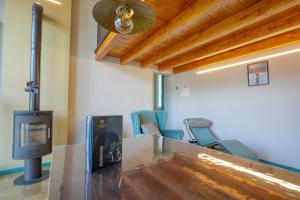 een kamer met een houtkachel en stoelen bij La Casetta di Renzo e Lucia in Olginate