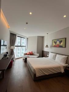 a hotel room with a large bed and a desk at APEC Mandala Mũi Né VIP in Mui Ne