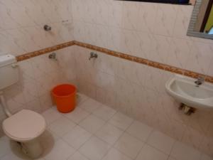 a bathroom with a toilet and a sink at Stay by Asharaf AS Villa in Varkala