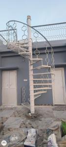 a metal spiral staircase in front of a building at Sree jee stay in Varanasi
