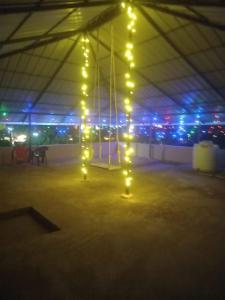 a large tent with lights and a swing at Stay by Asharaf AS Villa in Varkala