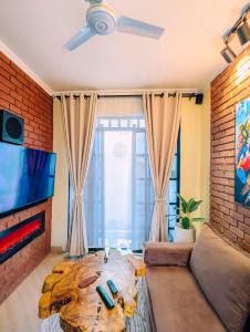 a living room with a couch and a tv at Kali Hideaway Experience Arusha in Arusha