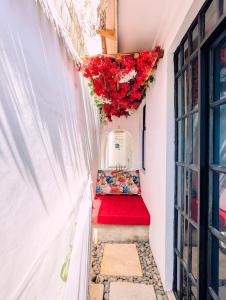 a stairway with a red carpet and flowers at Kali Hideaway Experience Arusha in Arusha