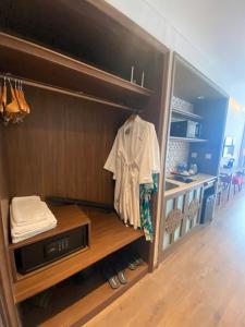 a room with a closet with a shirt on a shelf at APEC Mandala Mũi Né VIP in Mui Ne +26 photos
