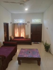 a living room with a couch and a table at White Horizon 2 in Ahangama