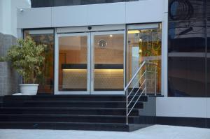 a glass building with stairs in front of it at Saionara Hotel in Rio de Janeiro