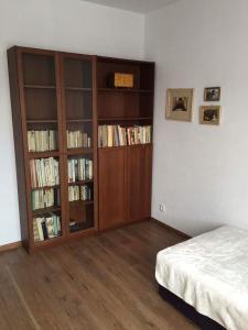 a bedroom with two book shelves and a bed at Apartman Elena in Kežmarok