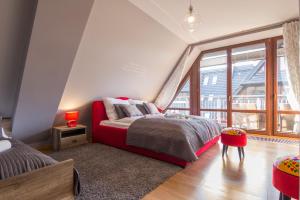 a bedroom with a large bed and a large window at Apartamenty Oaza Deluxe Zakopane in Zakopane