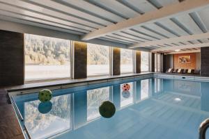 a swimming pool with a view of the mountains at Familienhotel Lagant in Brand