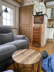 een woonkamer met een bank en een tafel bij atelier couture in Reiningue +3 foto's