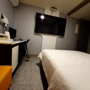 a hotel room with a bed and a desk with a computer at 스카이모텔 in Seoul