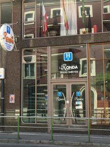 a store front of a building with glass doors at Hotel La Ronda in Castro-Urdiales