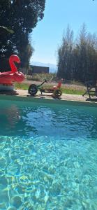 a pool of water with a red scooter next to it at Villa De Alexiano in Alixan