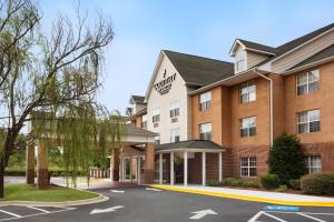 a rendering of a hotel with a parking lot at Country Inn & Suites by Radisson, Charlotte University Place, NC in Charlotte
