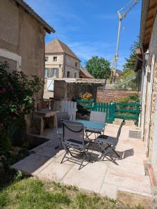 a table and chairs sitting on a patio at La Cachette Vigneronne in Givry