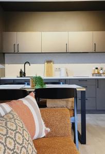 a kitchen with a table and a counter top at Leśniczanka in Brenna +7 photos