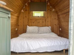 a bedroom with a bed in a wooden cabin at Birds - Uk48489 in Dalton in Furness