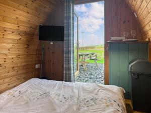 a bedroom with a bed and a view of a picnic table at Birds - Uk48489 in Dalton in Furness