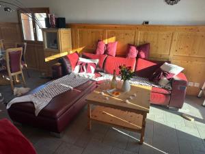 a living room with a couch and a table at Panorama-Chalet Unterbach in Hinwil