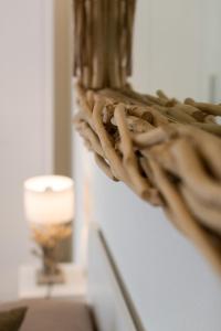 a wreath hanging on a wall next to a candle at Studio 27 in Ferrara