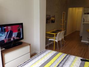 a bedroom with a bed and a flat screen tv at Studio Posto 6. in Rio de Janeiro