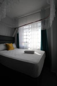 a bed in a room with a window at Modern 1-Bedroom Apartment Near Kisumu CBD, Free WiFi, Parking & Security in Kisumu +31 photos