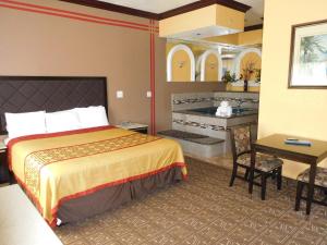 a hotel room with a bed and a bathroom at Diamond Inn in Inglewood