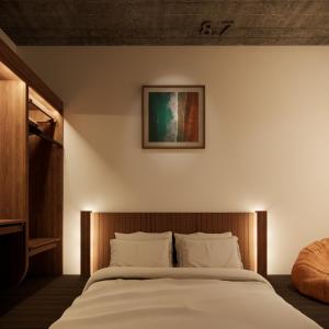 a bedroom with a large bed with white sheets at The Memory Danang Boutique in Da Nang