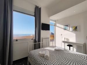 a bedroom with a bed and a large window at La Terrazza di Chiavari in Chiavari