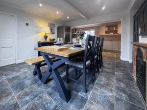eine Küche und ein Esszimmer mit einem Holztisch und Stühlen in der Unterkunft Hill House - Uk49727 in Oxborough