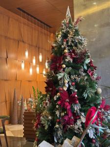 a christmas tree on a table in a room at Citea Apart Hotel in Beirut
