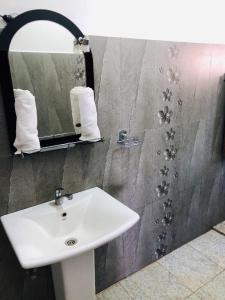 a bathroom with a white sink and a mirror at Villa Arcadia in Tangalle +16 photos