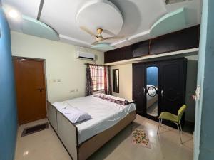 een slaapkamer met een bed en een plafondventilator bij Lakefront Villa in Manipala +7 foto's