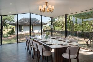 a large dining room with a long table and chairs at SaffronStays La Mia Casa in Jāmb