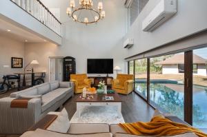 a living room with a couch and a table at SaffronStays La Mia Casa in Jāmb