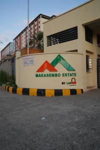 a sign on the side of a building at Modern 1-Bedroom Apartment Near Kisumu CBD, Free WiFi, Parking & Security in Kisumu