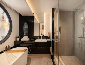 a bathroom with a shower and a sink at Na U Hotel in Chiang Mai