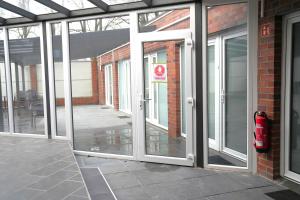 an open sliding glass door on a building at Hotel am Schürblick in Gronau