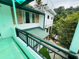 a balcony of a house with a green railing at 35-B-5 Kandy in Kandy