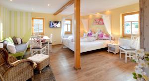 een slaapkamer met een bed en een woonkamer bij Elferhof Ferienwohnungen in Mohlsdorf