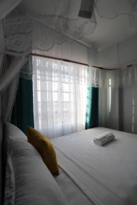 a bed in a room with a window and a mattress at Modern 1-Bedroom Apartment Near Kisumu CBD, Free WiFi, Parking & Security in Kisumu