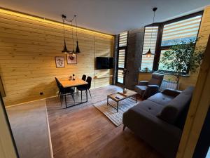 a living room with a couch and a table at Flora Hotel Apartment 103 in Borovets